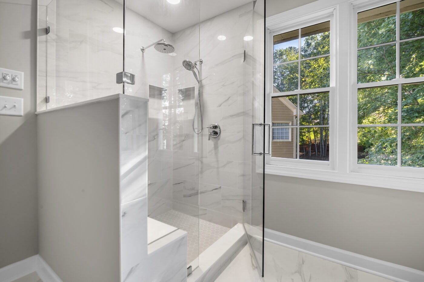 Custom tiled walk-in shower from a tub-to-shower conversion